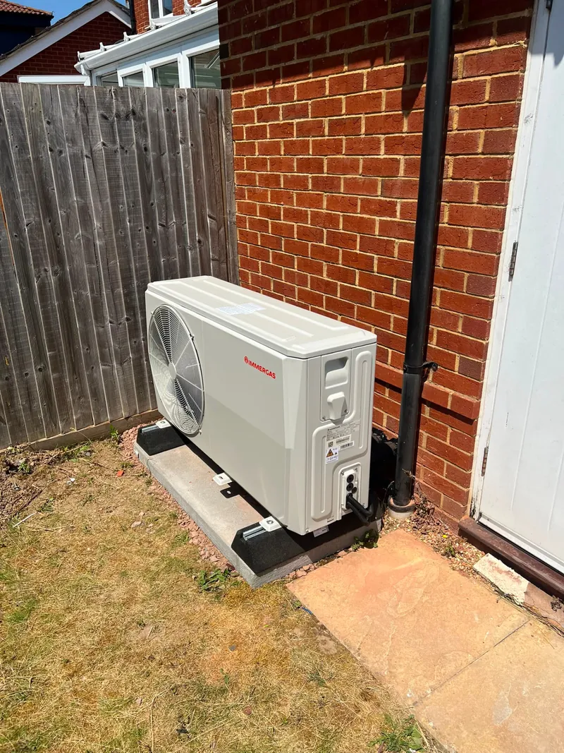 Air source heat pump installed on a concrete base outside a Hampshire home