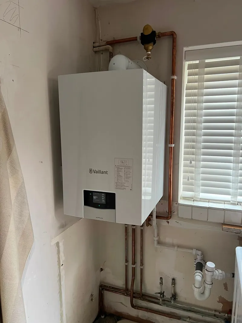 Vaillant boiler installation with tidy copper pipework by a window