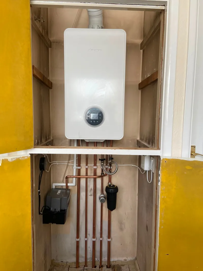 Worcester boiler installed inside a yellow cupboard with filter