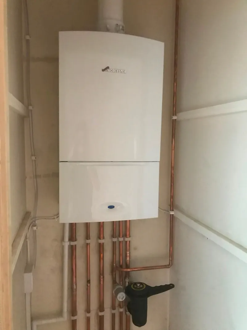 Worcester boiler mounted in a compact cupboard with system filter