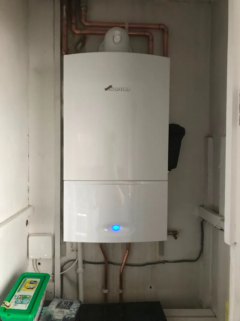 Worcester boiler installed in a cupboard next to heating controls