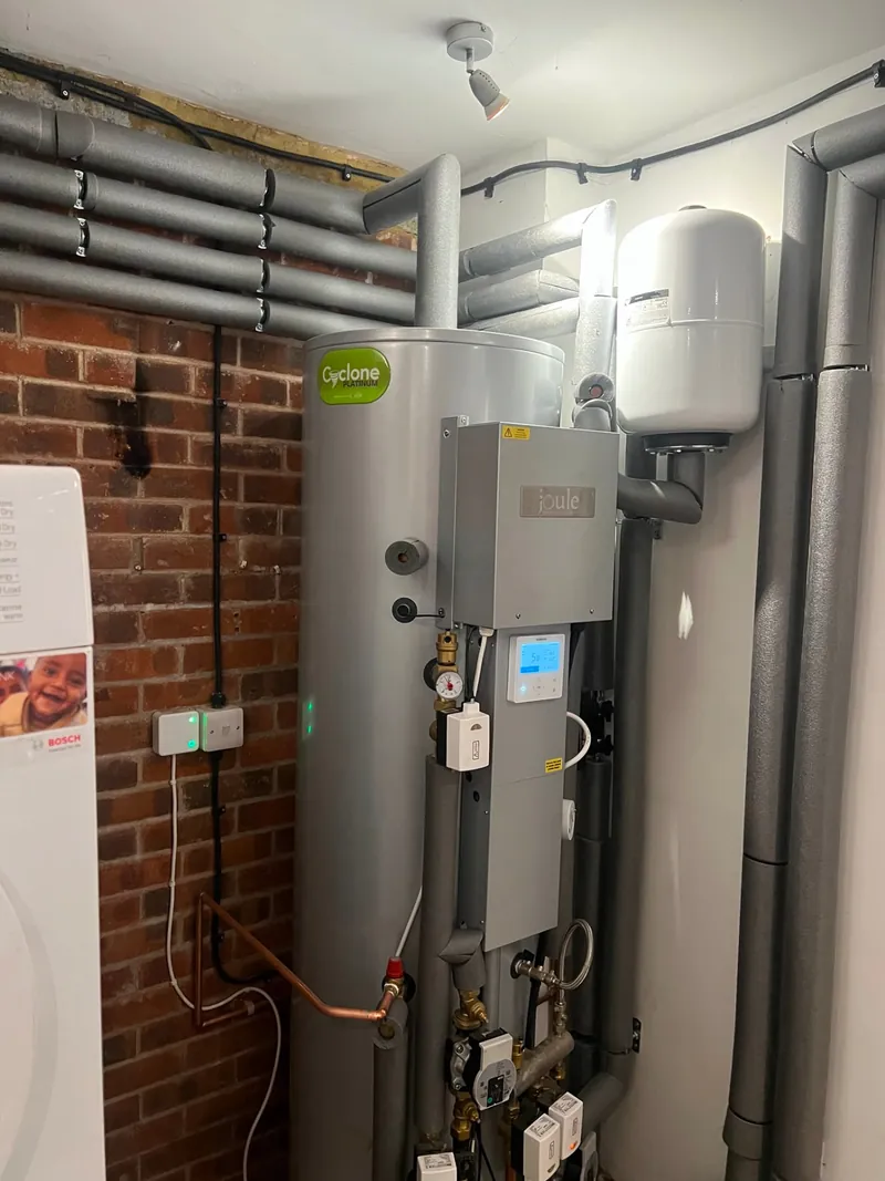 Heat pump hot water cylinder and controls with insulated pipework