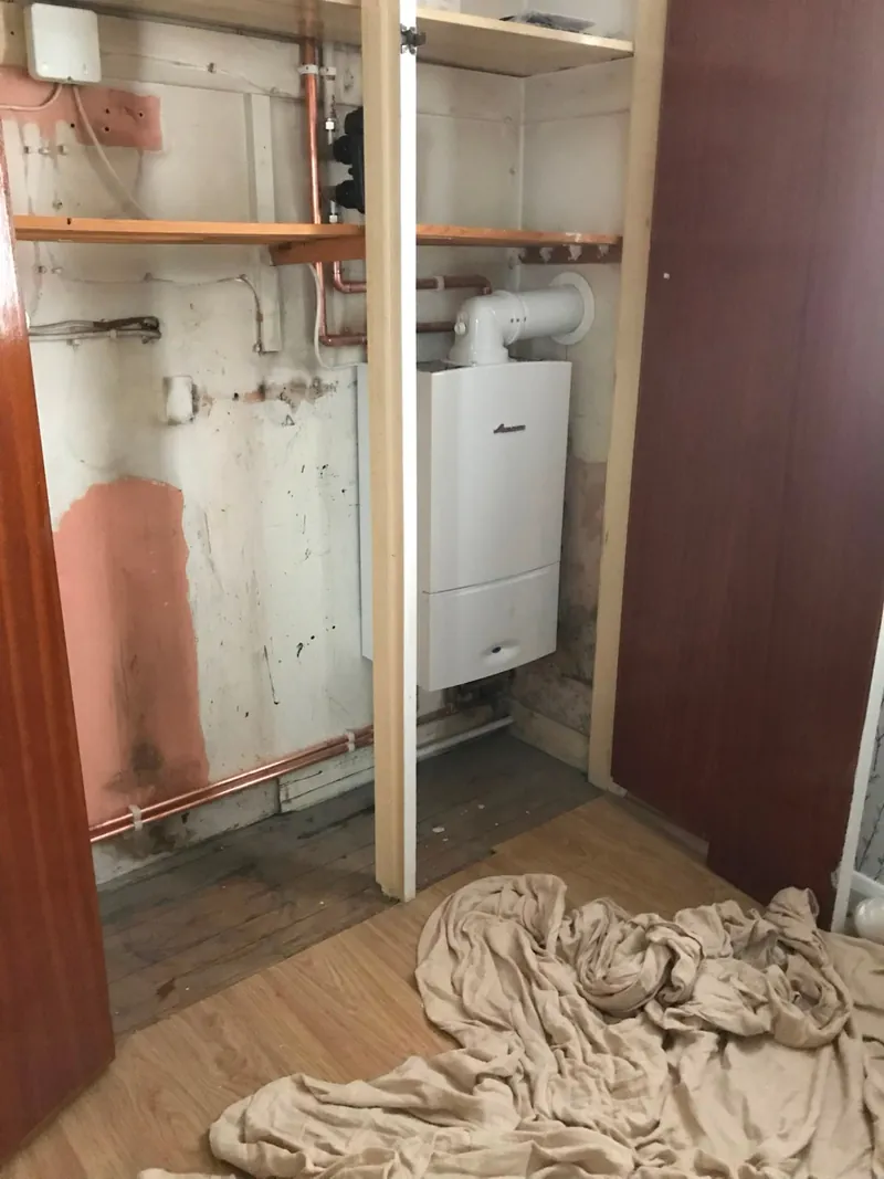 New boiler installation in a cupboard with copper pipework